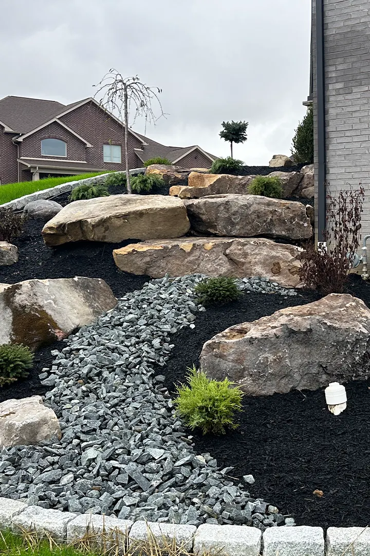Decorative boulder installation for landscaping in Pittsburgh