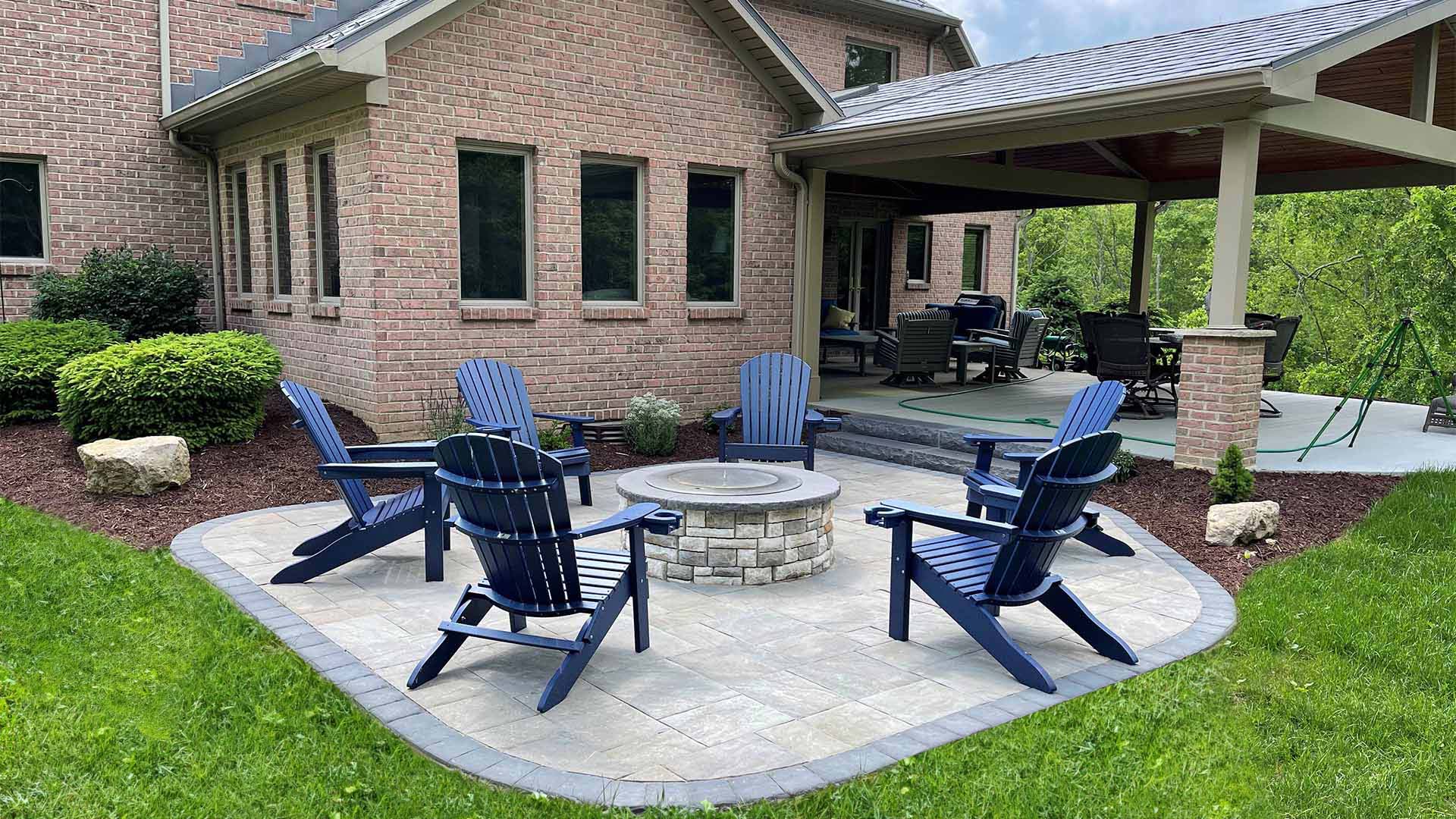 a Full grass lawn surrounding a patio